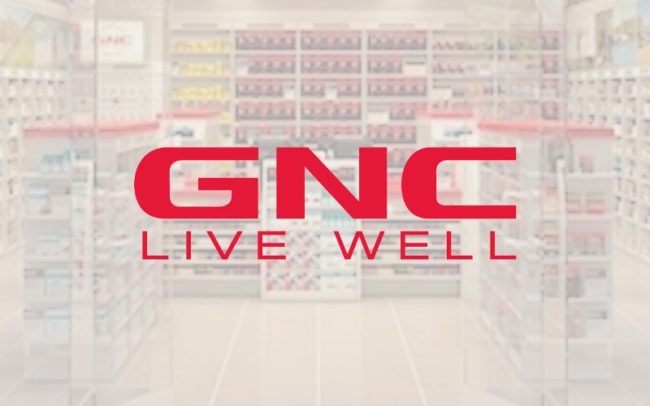 GNC logo at Palouse Place overlaid on image of store from outside the entrance