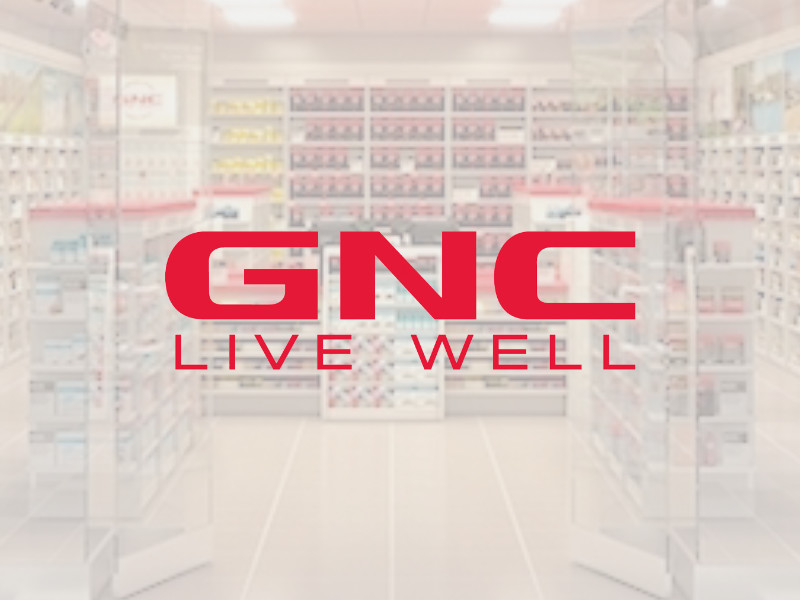GNC logo at Palouse Place overlaid on image of store from outside the entrance