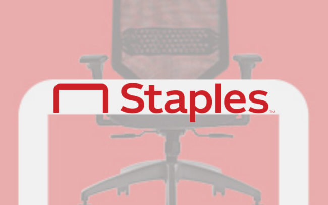 Staples logo overlaid on an image of an office chair with desk